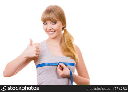 Fitness woman fit girl with measure tape measuring her chest breasts showing thumb up hand sign isolated on white. woman measuring her chest breasts isolated
