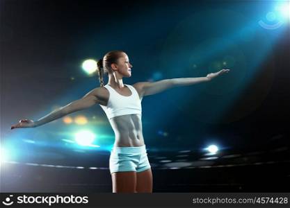 Fitness woman. Fitness woman standing against color lights background