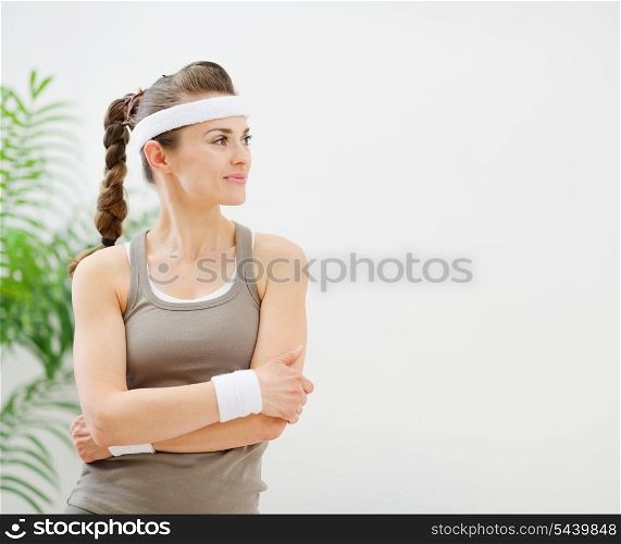 Fitness woman in sportswear looking on copy space