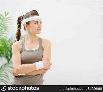 Fitness woman in sportswear looking on copy space