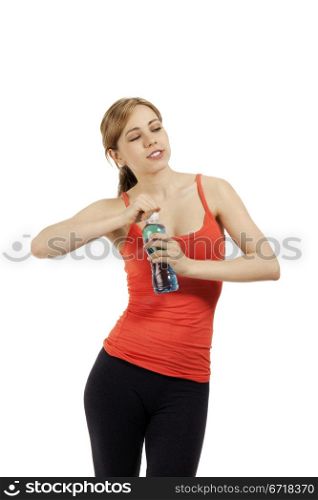 fitness woman opening a bottle of water looking to side. young cute fitness woman opening a bottle of water looking to side on white background