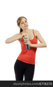 fitness woman opening a bottle of water looking to side. young cute fitness woman opening a bottle of water looking to side on white background
