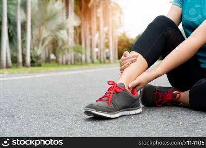 fitness woman runner feel pain on ankle leg. Outdoor exercise activities concept