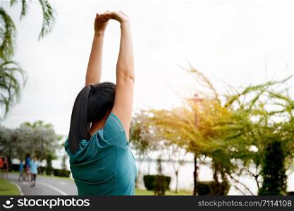 fitness woman runner stretching arm before run. Outdoor exercise activities concept