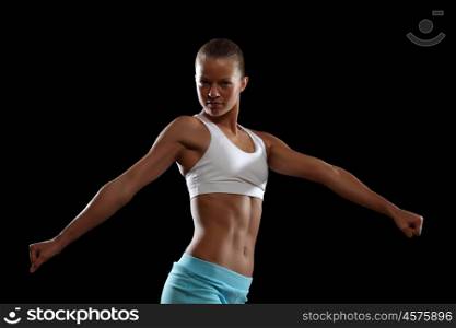 Fitness woman smiling. Fitness woman smiling standing against black background