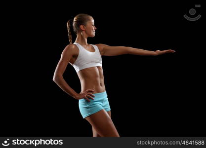 Fitness woman smiling. Fitness woman smiling standing against black background