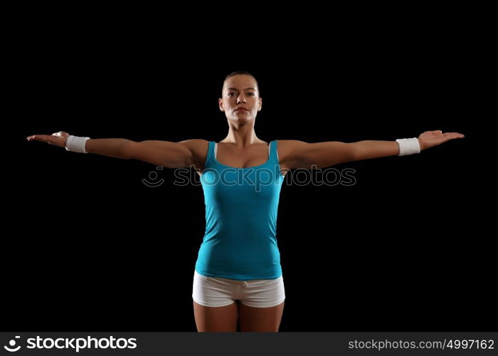 Fitness woman smiling. Fitness woman smiling standing against black background