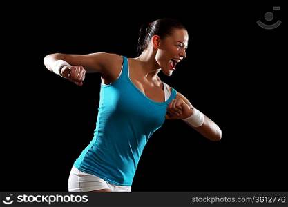 Fitness woman smiling standing against black background