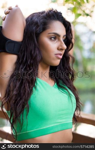 Fitness woman stretching her body in the park