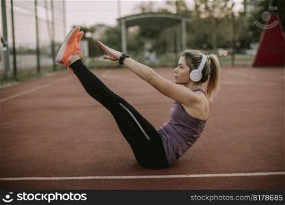 Fitness woman training abs workout at outdoor court