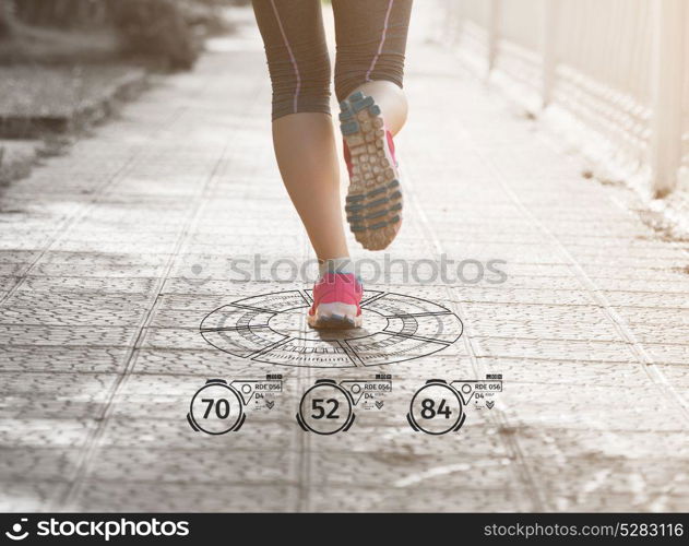 Fitness woman training and jogging in summer park, close up on running legs