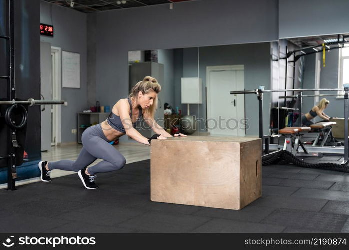 Fitness woman with a beautiful body on white background. Fitness young woman with a beautiful body