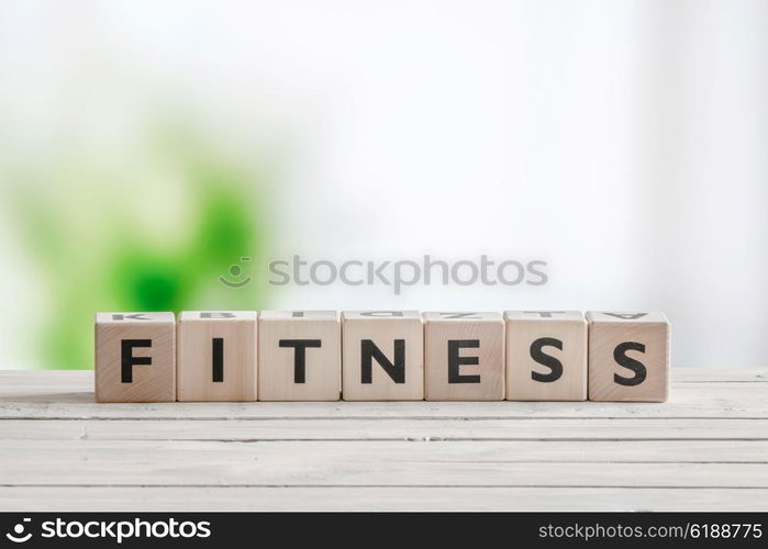 Fitness word sign on a wooden table in bright light