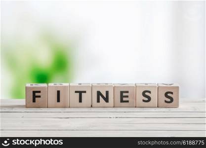 Fitness word sign on a wooden table in bright light