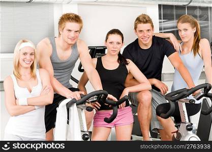 Fitness young group people at gym bicycle portrait