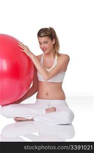 Fitness - Young happy woman with exercise ball on white background