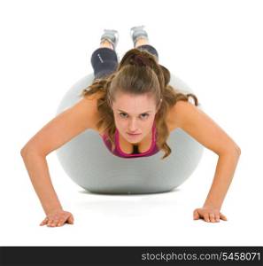 Fitness young woman doing push ups on fitness ball