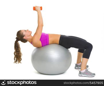 Fitness young woman making exercise with dumbbells on fitness ball