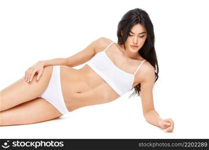 Fitness young woman with a beFitness young woman with a beautiful body sitting on white background.autiful body sitting on white background. High quality photo. Fitness young woman with a beautiful body sitting on white background
