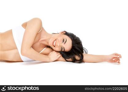 Fitness young woman with a beFitness young woman with a beautiful body sitting on white background.autiful body sitting on white background. High quality photo. Fitness young woman with a beautiful body sitting on white background