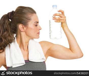 Fitness young woman with bottle of water showing biceps