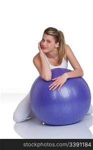 Fitness - Young woman with exercise ball on white background
