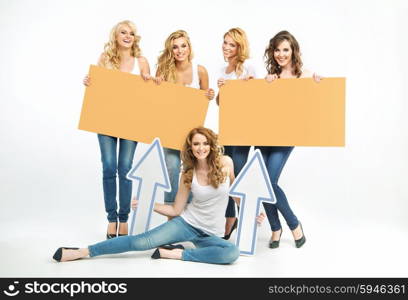 Five attractive ladies holding boards and arrows