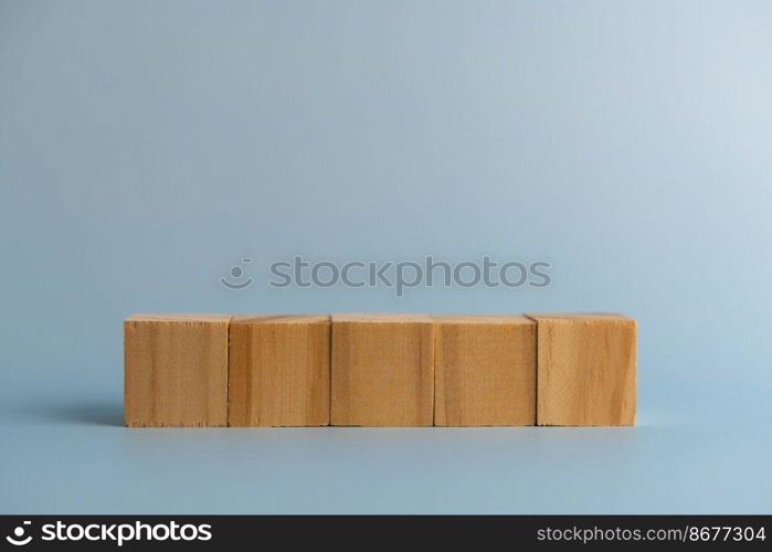 Five blank wooden block cubes on background for your text. Business concept template and banner.