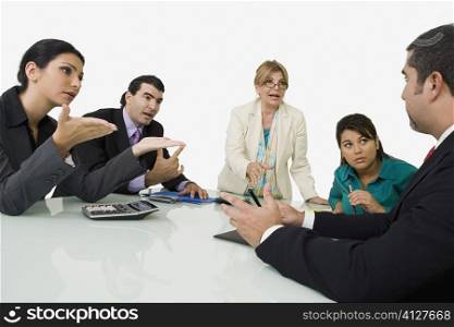 Five business executives discussing in a meeting