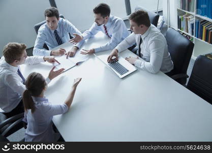 Five business people having a business meeting at the table in the office