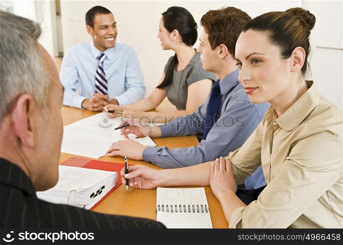 Five businesspeople in a meeting