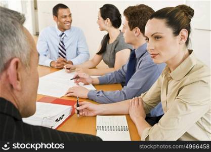 Five businesspeople in a meeting