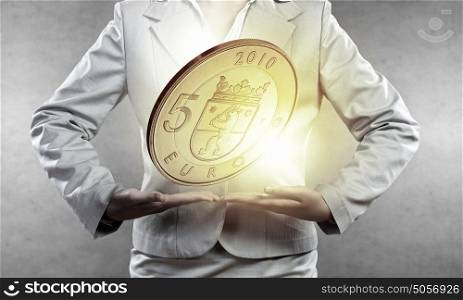 Five euro. Close up of businesswoman holding in palms euro coin