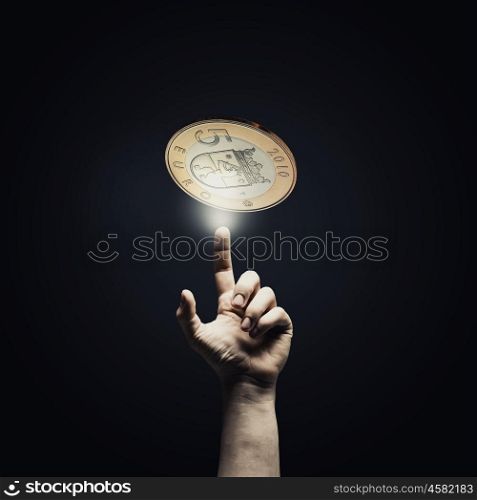 Five euro. Human hand pointing with finger at euro coin