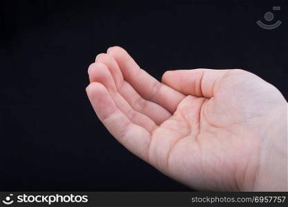 Five fingers of a human hand partly seen in view. Five fingers of a child hand partly seen in black background