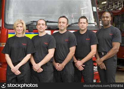 Five firefighters standing in front of fire engine
