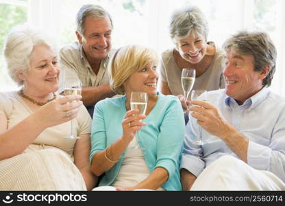 Five friends in living room drinking champagne and smiling