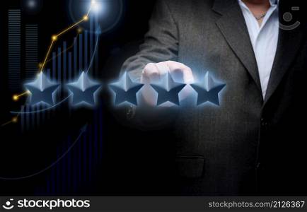five holographic stars and a man&rsquo;s hand on a dark blue background. Business evaluation concept by users, rating and voting