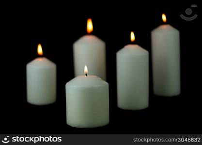 Five light flame candle burning brightly on black background