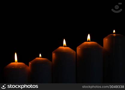 Five light flame candle burning brightly on black background