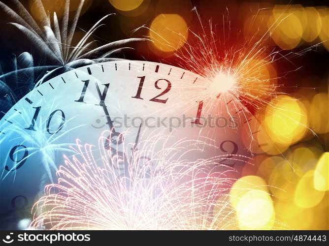 Five minutes to twelve. Conceptual image of clock with bokeh lights and firework