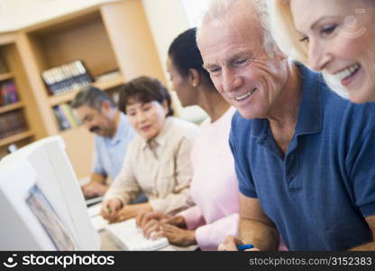 Five people at computer terminals in library (depth of field)