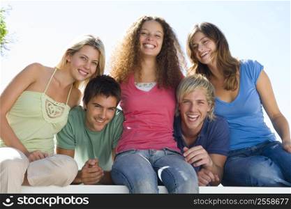 Five people on balcony smiling