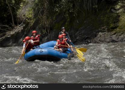 Five people rafting in a river