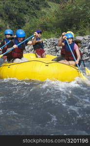 Five people rafting in a river
