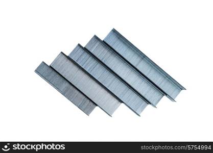 five reems of different size staples lying one next to the other on an isolated white background.