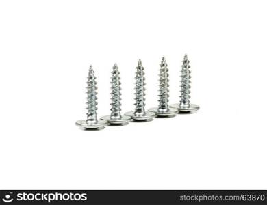 Five self-tapping screws of the same size on a light background