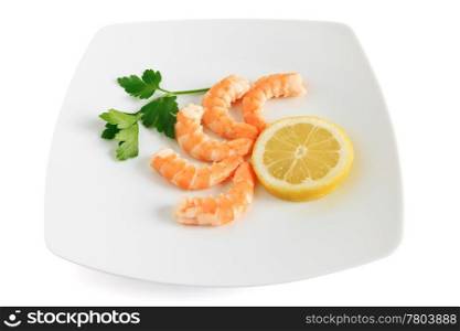 five shelled shrimps with lemon and parsley on a plate isolated on white background with clipping path
