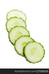Five slices of English cucumber, cut and ready for a salad or garnish. Shot on white background.