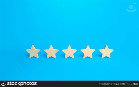 Five stars on a blue background. Rating evaluation concept. High satisfaction. Good reputation. Popularity rating of restaurants, hotels or mobile applications. Highest score. Service quality feedback